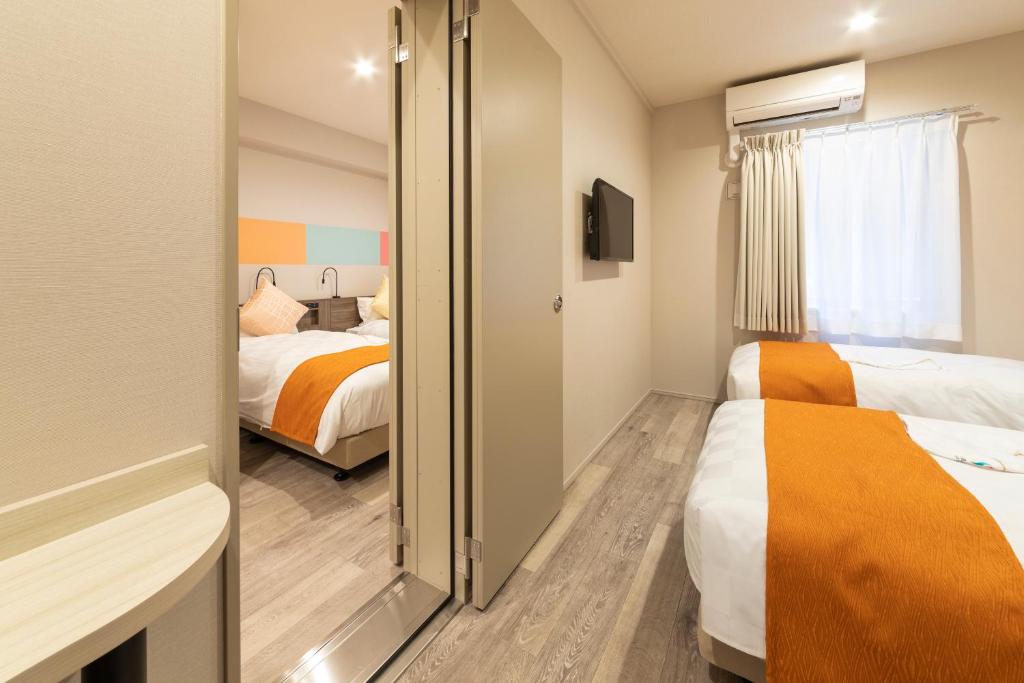Postel nebo postele na pokoji v ubytování SARASA HOTEL Dotonbori