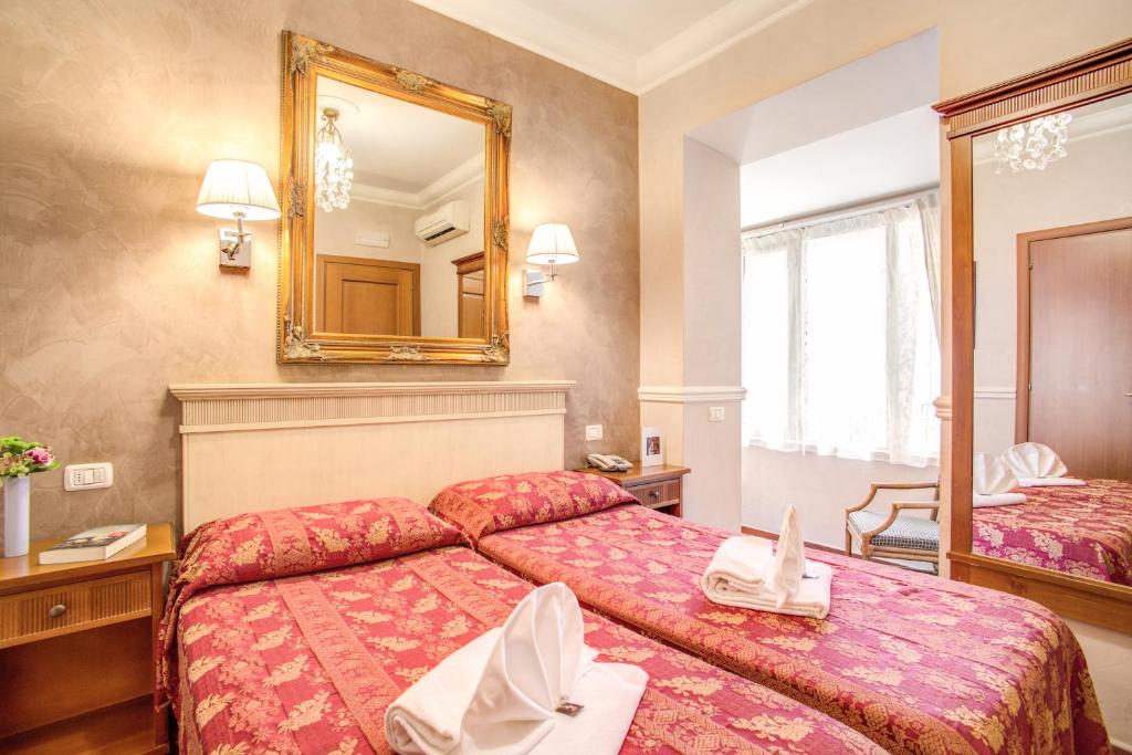 Postel nebo postele na pokoji v ubytování Hotel Caravaggio