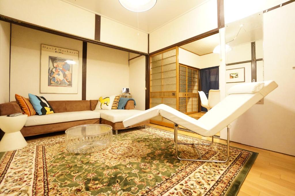 a living room with a couch and a table at Rainbow Takayama Private House in Takayama