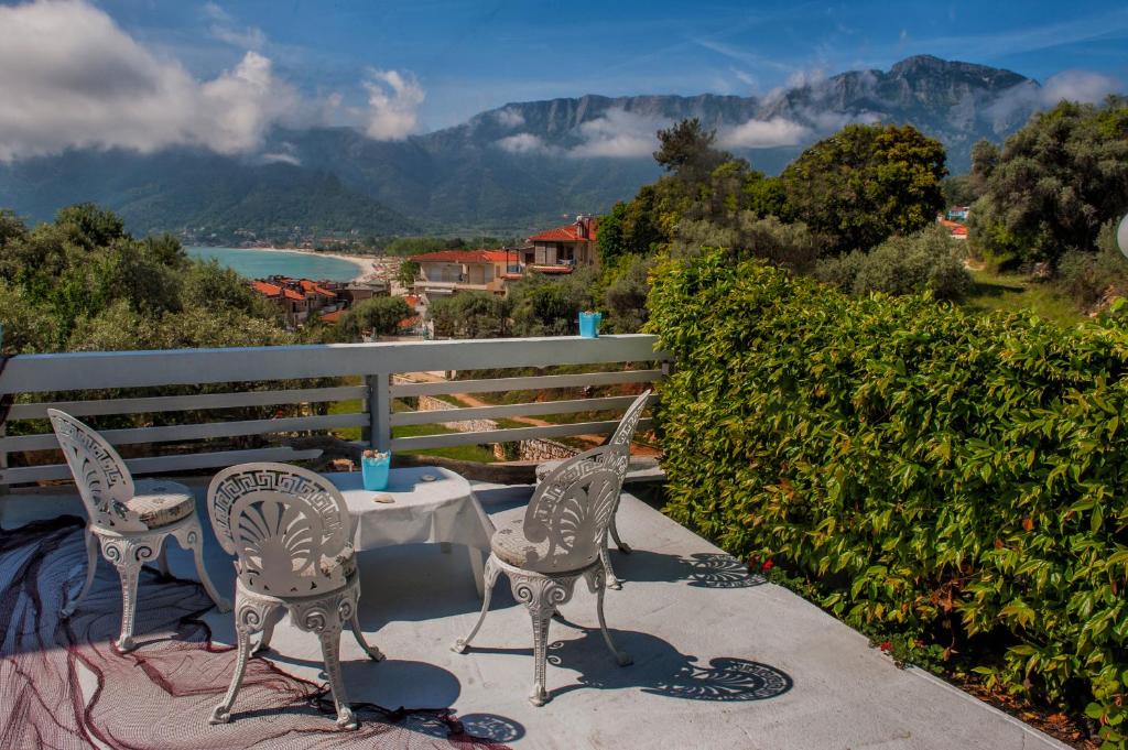 a table and chairs on a patio with a view of mountains at D&P House in Chrysi Ammoudia