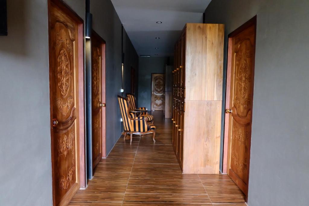 a hallway with chairs and a table in a room at Bloom Cafe & Hostel in Ko Lipe