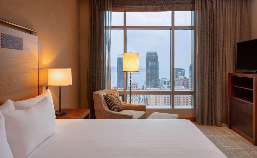 a hotel room with a bed and a large window at Grand Hyatt Seattle in Seattle