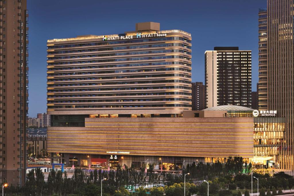 a large building in a city with tall buildings at Hyatt Place Yinchuan Yuecaicheng in Yinchuan