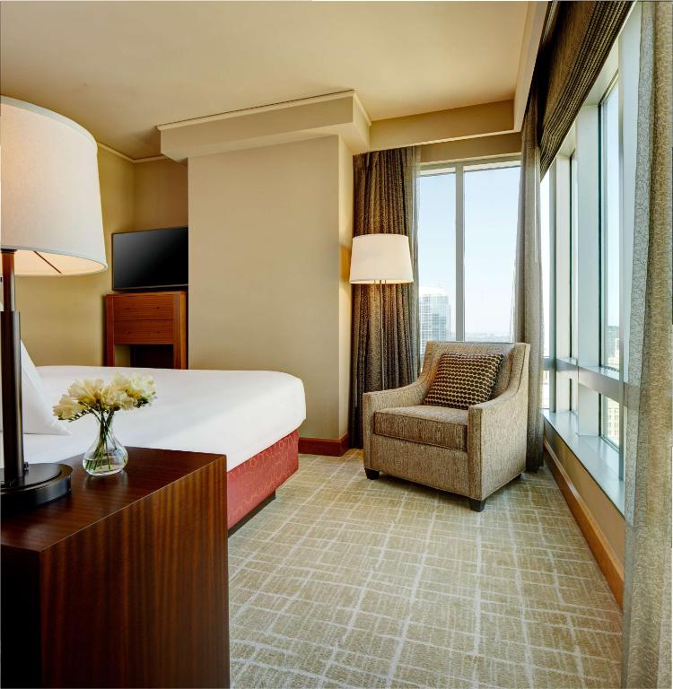 a hotel room with a bed and a chair at Grand Hyatt Seattle in Seattle