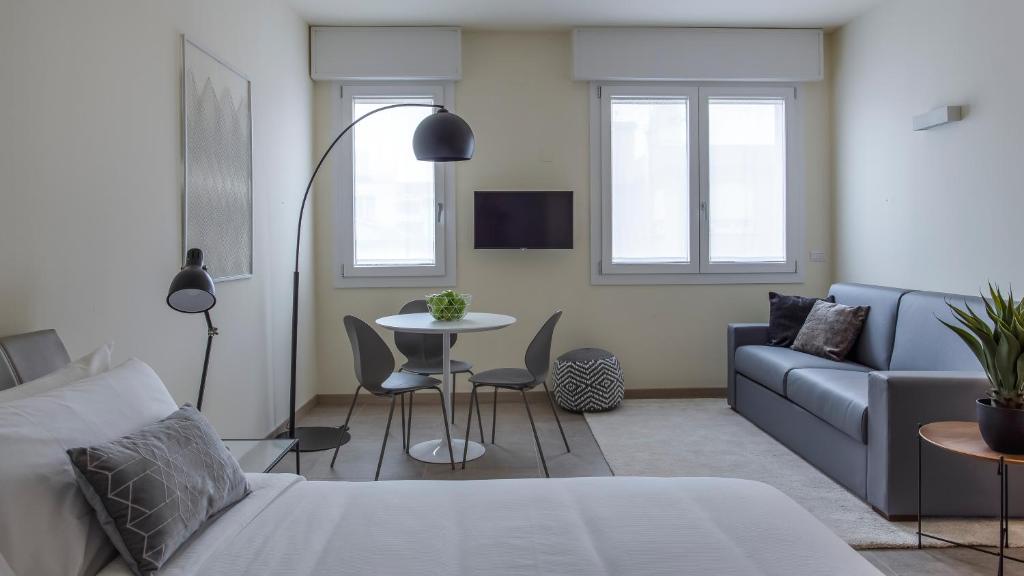 a living room with a couch and a table at Erïk Langer Pedrocchi Suites in Padova