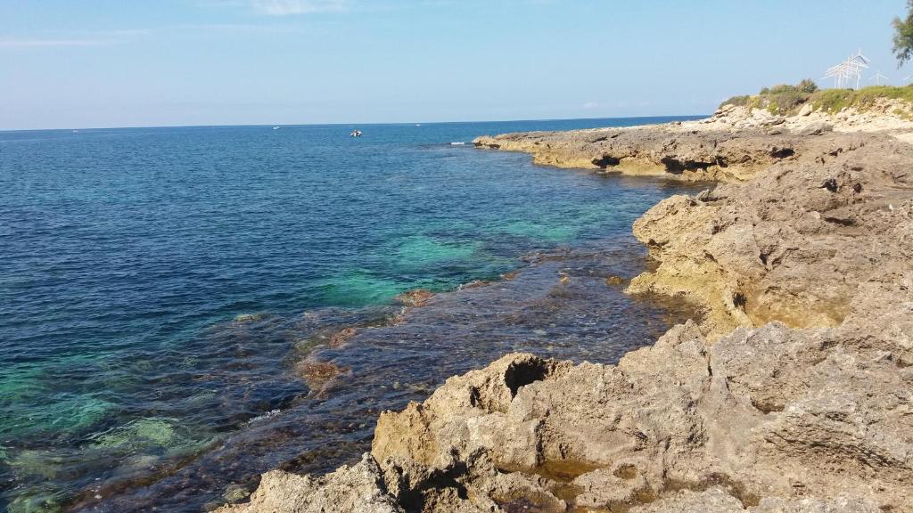 a view of the ocean from a rocky shore at Villa A DUE PASSI DAL MARE in Taranto