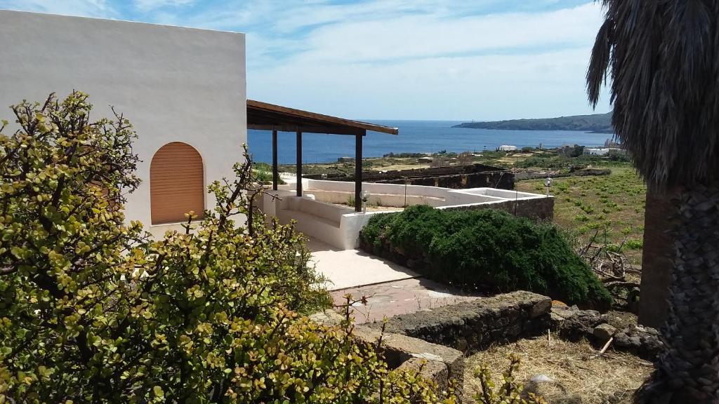 a white house with a view of the ocean at Marosi in Pantelleria