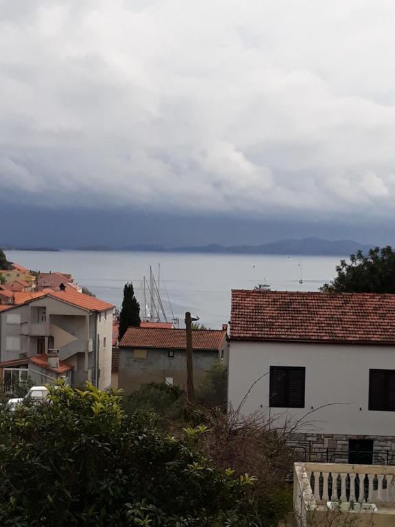 a view of the ocean from a city with buildings at Frka Petešić in Sali