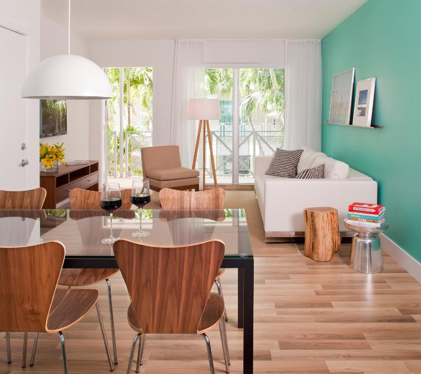 a living room with a dining table and chairs at 1818 Meridian House Apartments and Suites by Eskape Collection in Miami Beach