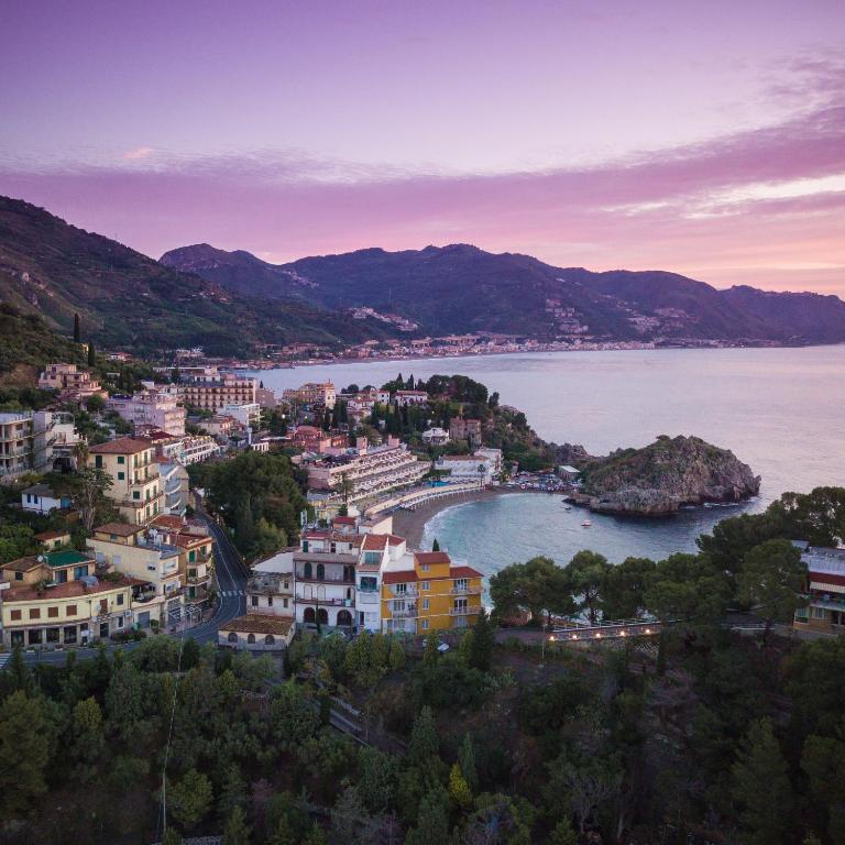 a view of a town and a body of water at Taormina Panoramic Hotel in Taormina