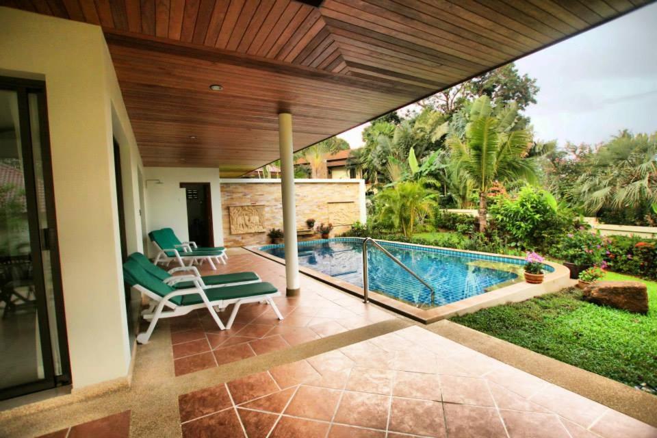 a house with a swimming pool in a yard at Lai Thai Villa in Rawai Beach