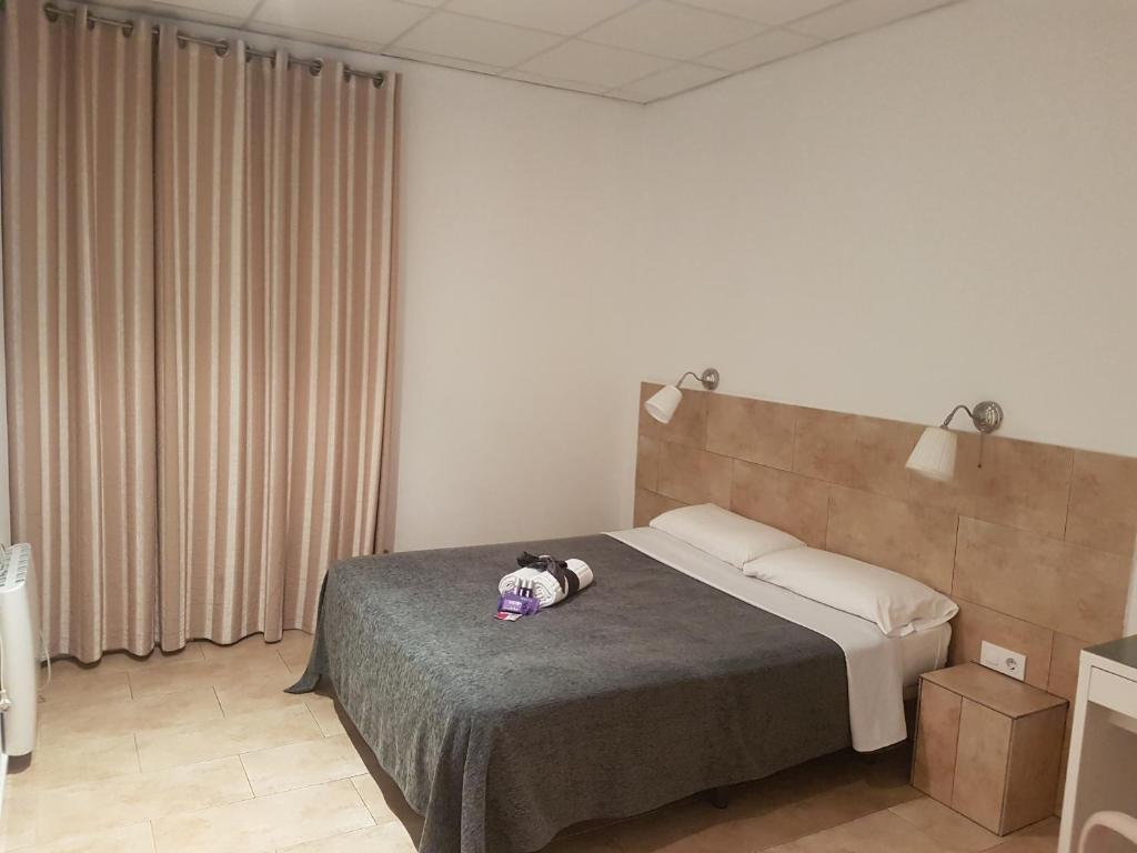 Posteľ alebo postele v izbe v ubytovaní Hostal Martinval