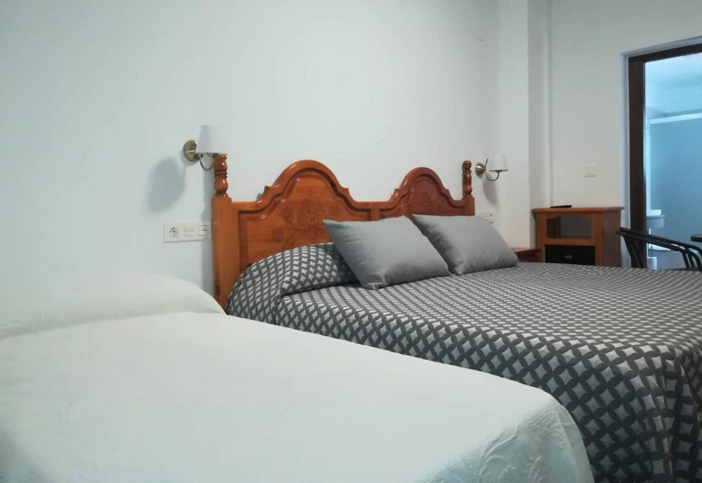 Posteľ alebo postele v izbe v ubytovaní Hostal y Apartamento Rural Los Naranjos