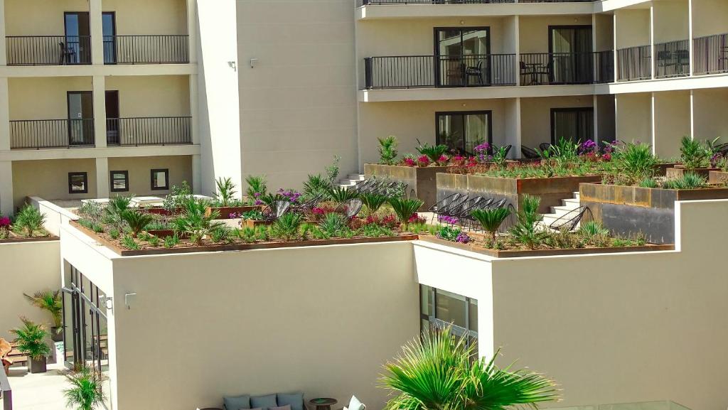 an apartment building with plants on the balconies at Hotel Paradiso Garden in Playa de Palma