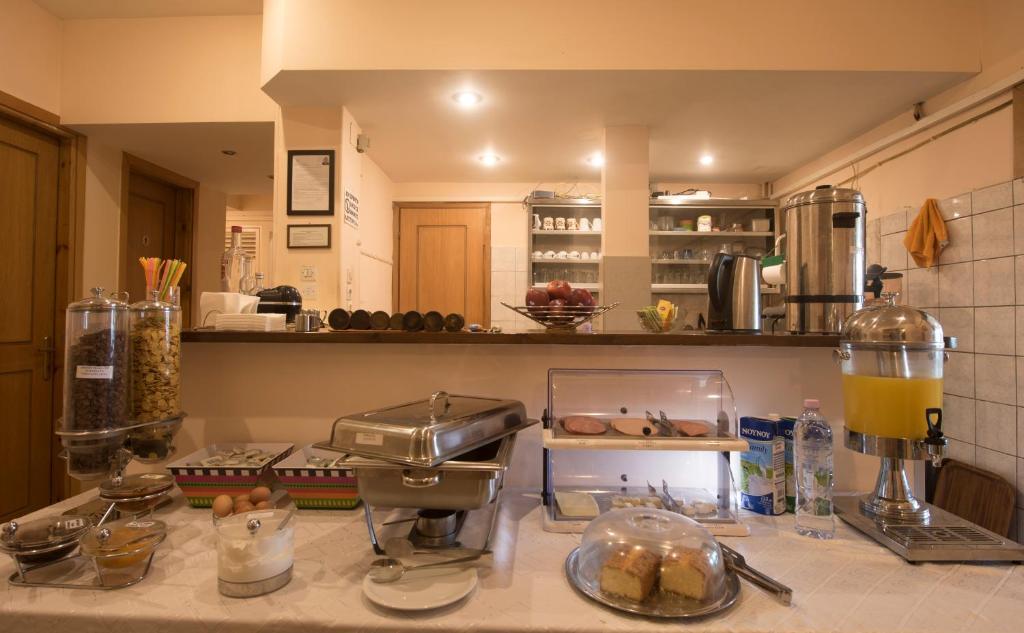 a kitchen with a counter with some food on it at Filoxenia Hotel in Volos