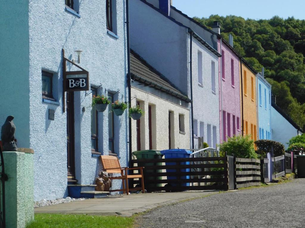 a row of colorful houses on a street at Creag Dubh Bed & Breakfast in Kyle of Lochalsh