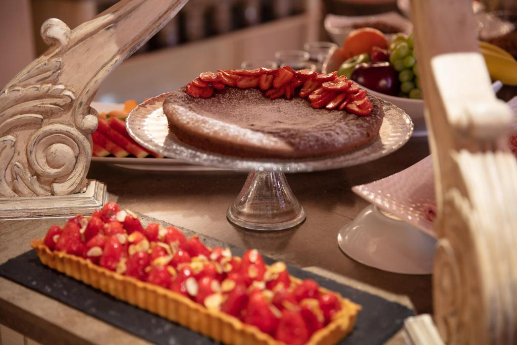 a table topped with a cake with red fruit on top at Le Cavendish in Cannes