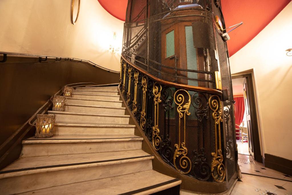 a set of stairs with a wrought iron railing at Le Cavendish in Cannes