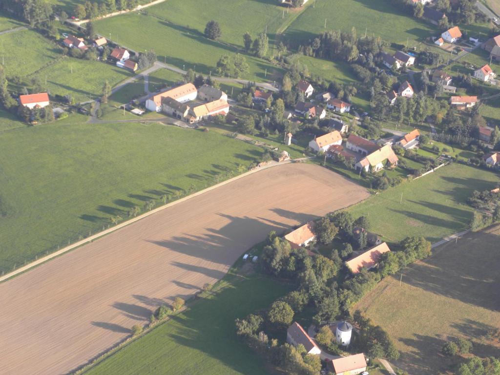 an aerial view of a farm with a field and houses at Fewo Mühlehof in Königshain