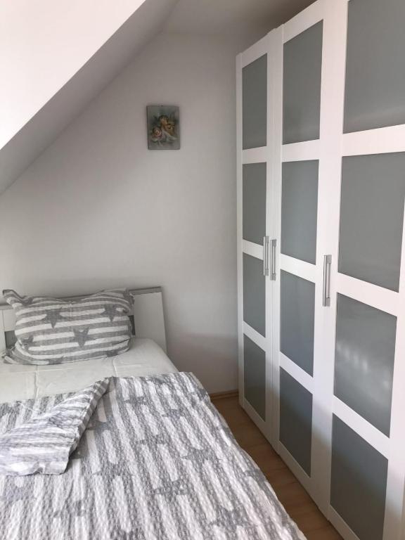 a bedroom with a bed and a sliding door at Pensione da Vito in Greifswald
