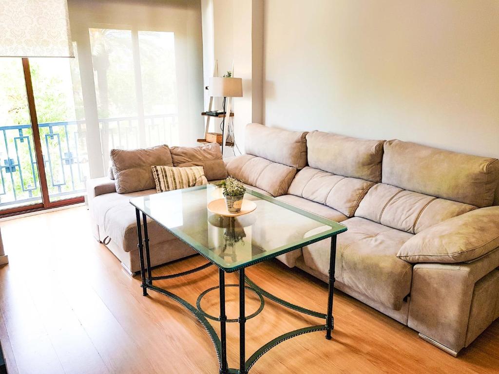 a living room with a couch and a glass table at Paseo de La Victoria in Córdoba