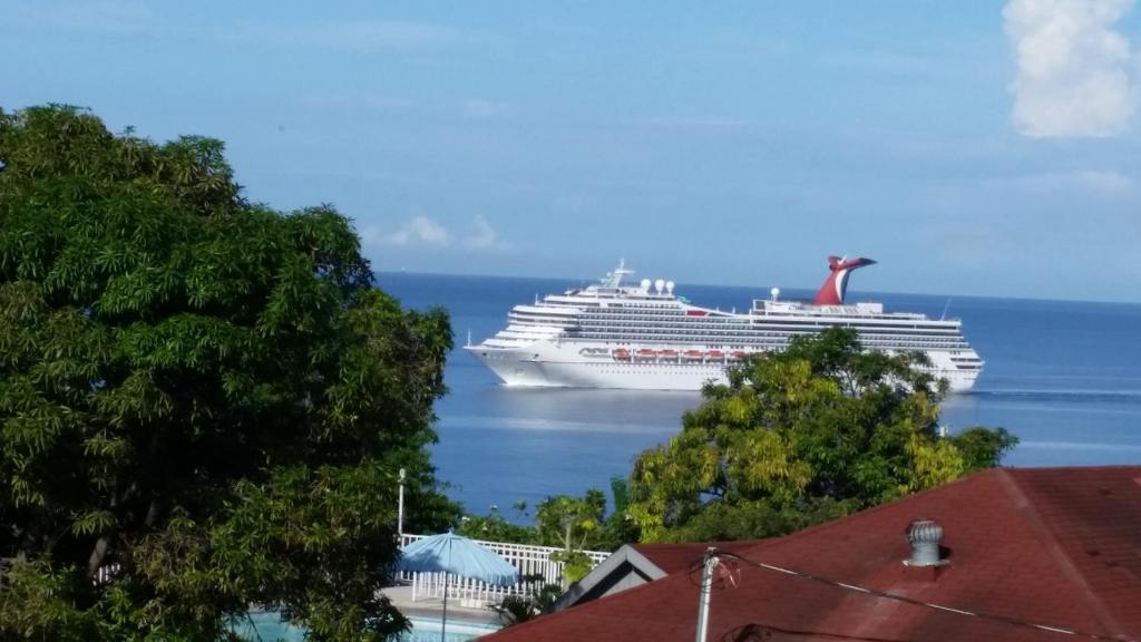 a cruise ship is docked in the water at Ocean View Montego Bay Apartment in Montego Bay