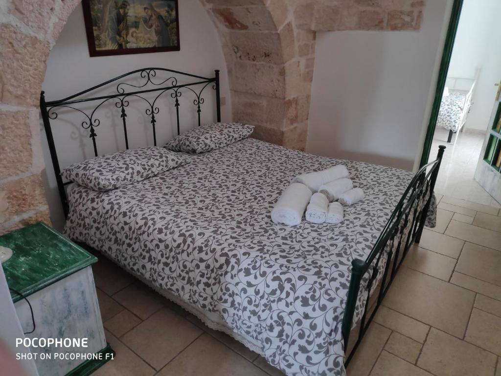 a bedroom with a bed with two pillows on it at Dimora Sumerano in Alberobello