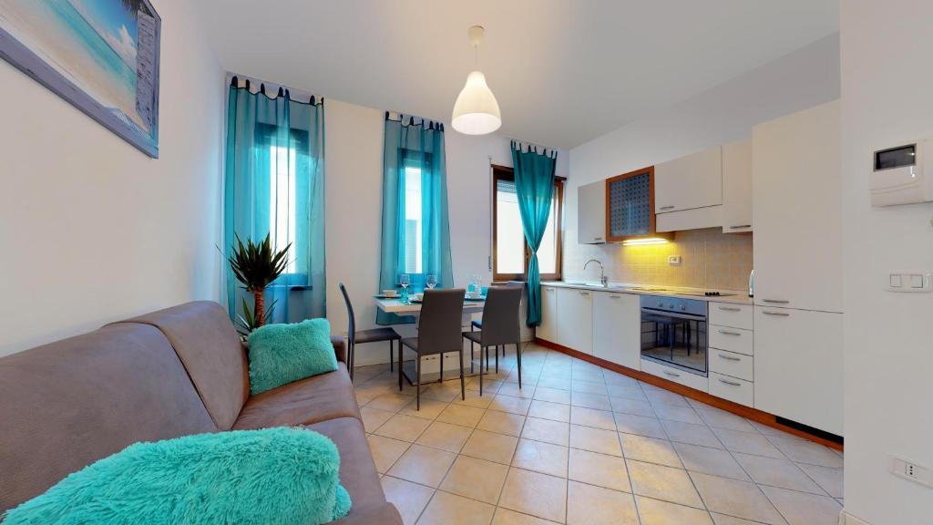 a living room and kitchen with a couch and a table at Terme Romane in Riva del Garda