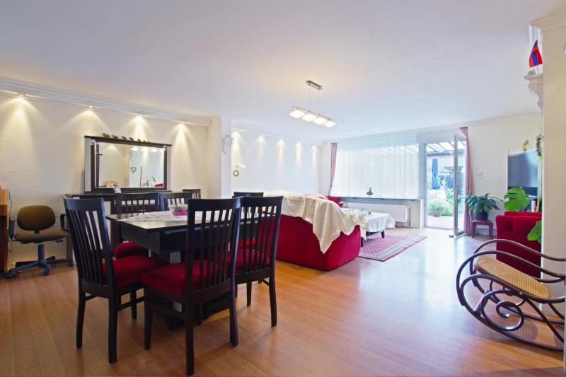 a living room with a table and chairs and a couch at Private Apartment in Hannover