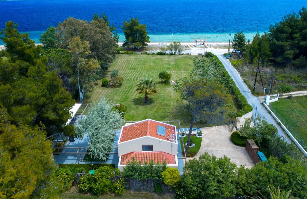 an aerial view of a house with a view of the ocean at Tiamo Secrets - Palm Garden in Vourvourou