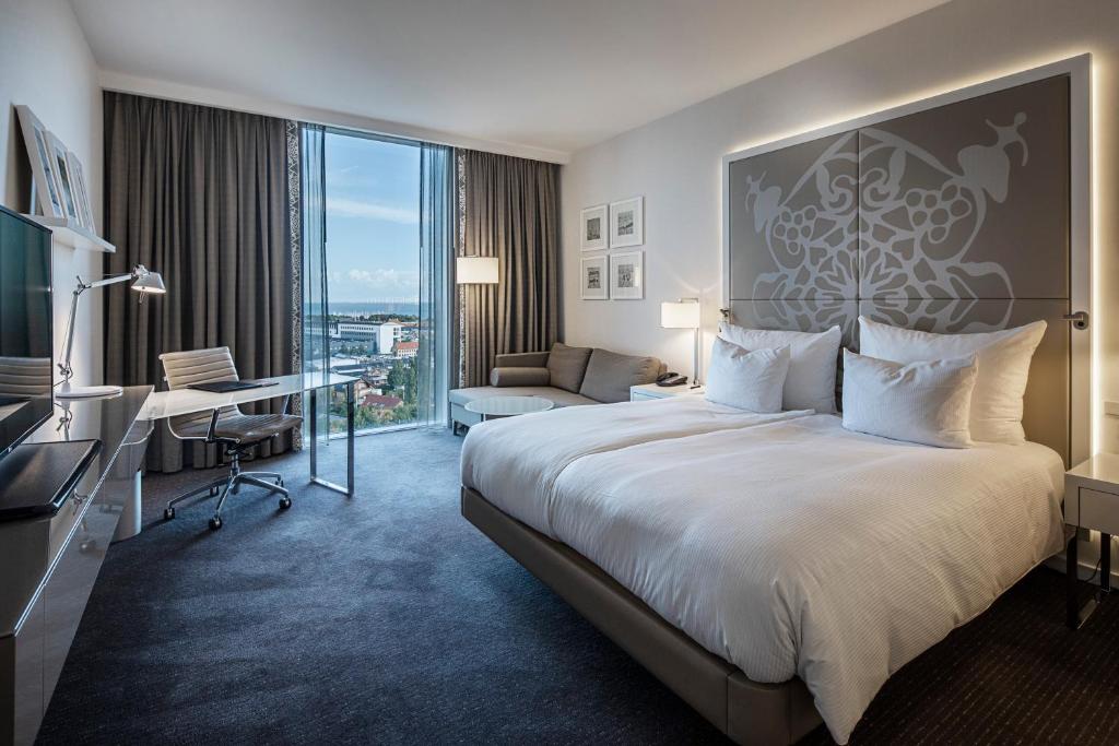 a hotel room with a large bed and a desk at Clarion Hotel Copenhagen Airport in Copenhagen