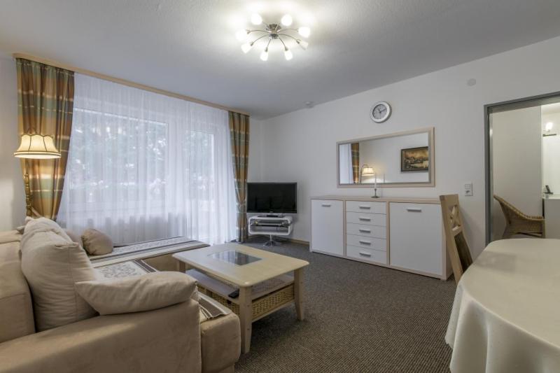 a living room with a couch and a table at Private Apartment in Hannover