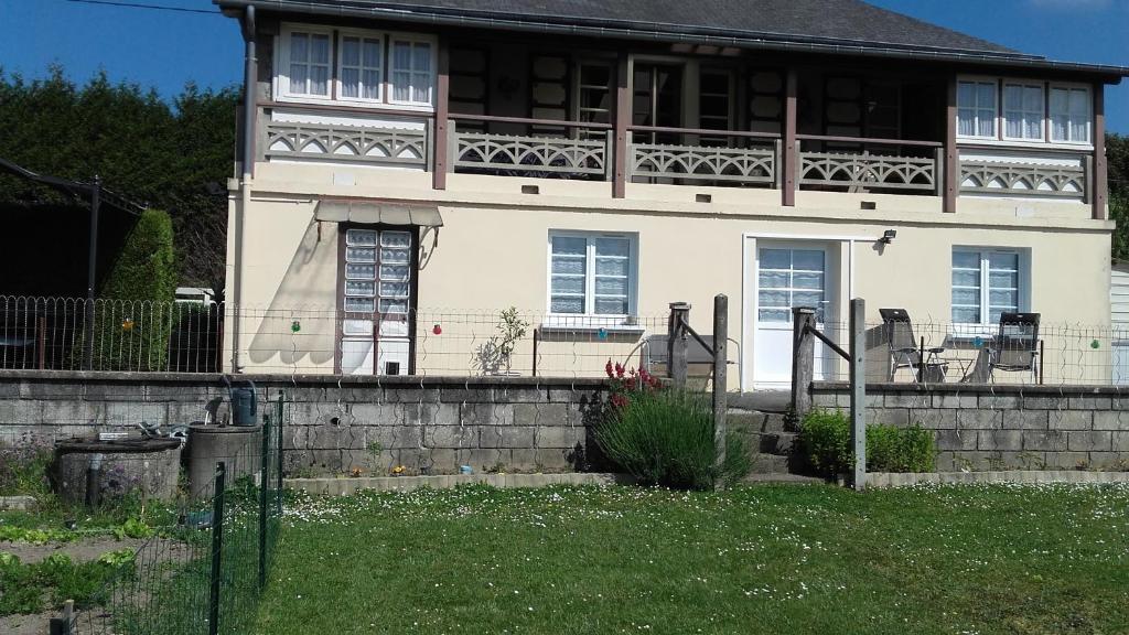 a white house with a balcony on top of it at " autour de la Baie " in Pleine-Fougères