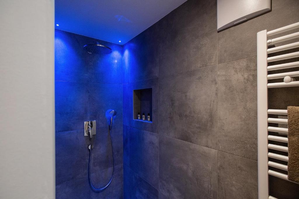 a bathroom with a shower with a blue ceiling at Residence Rösch in Merano