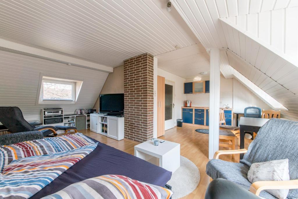 a living room with a couch and a table at Private Apartment in Hannover