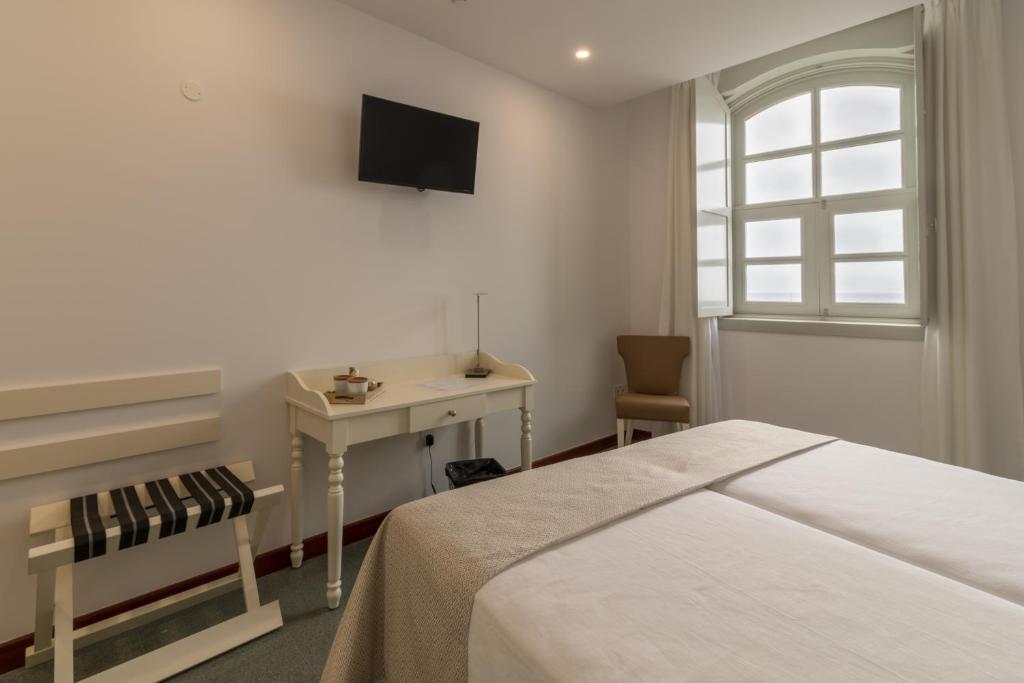 TV a/nebo společenská místnost v ubytování Hotel Emblemático Holiday Time