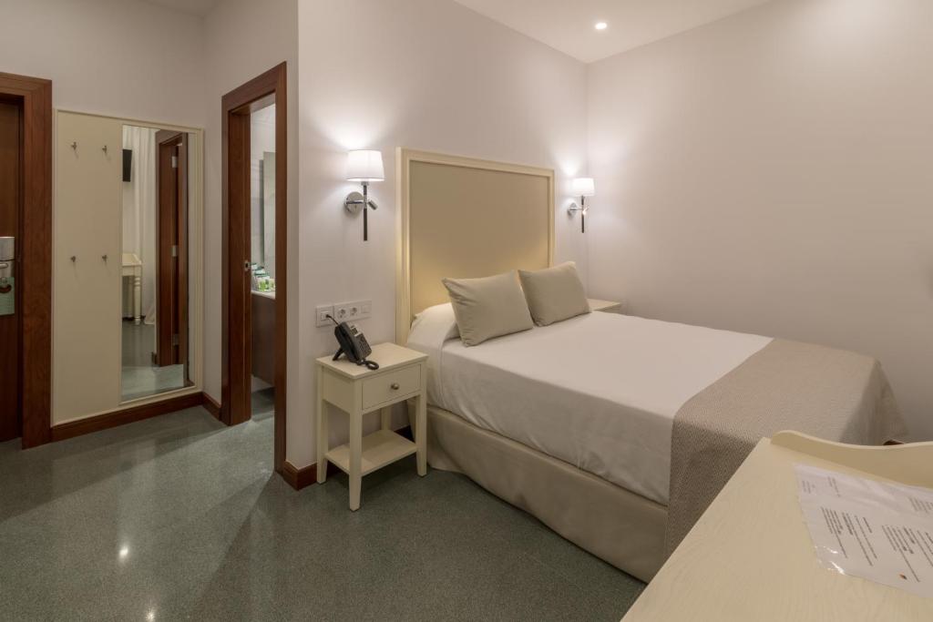 Postel nebo postele na pokoji v ubytování Hotel Emblemático Holiday Time