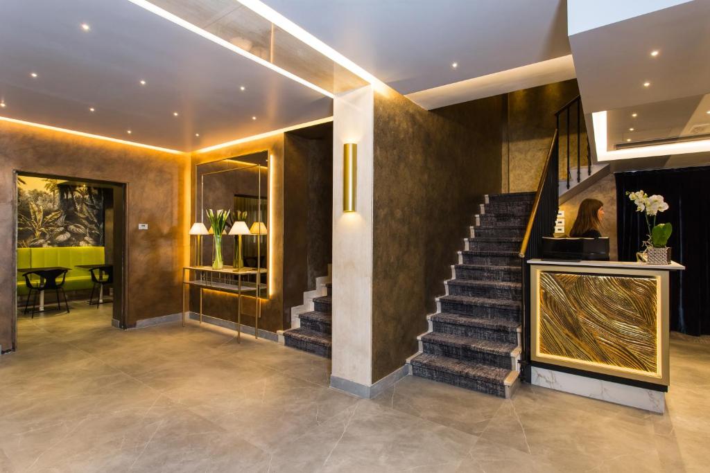 a lobby with a staircase and a stair case at Venice Maggior Consiglio in Venice