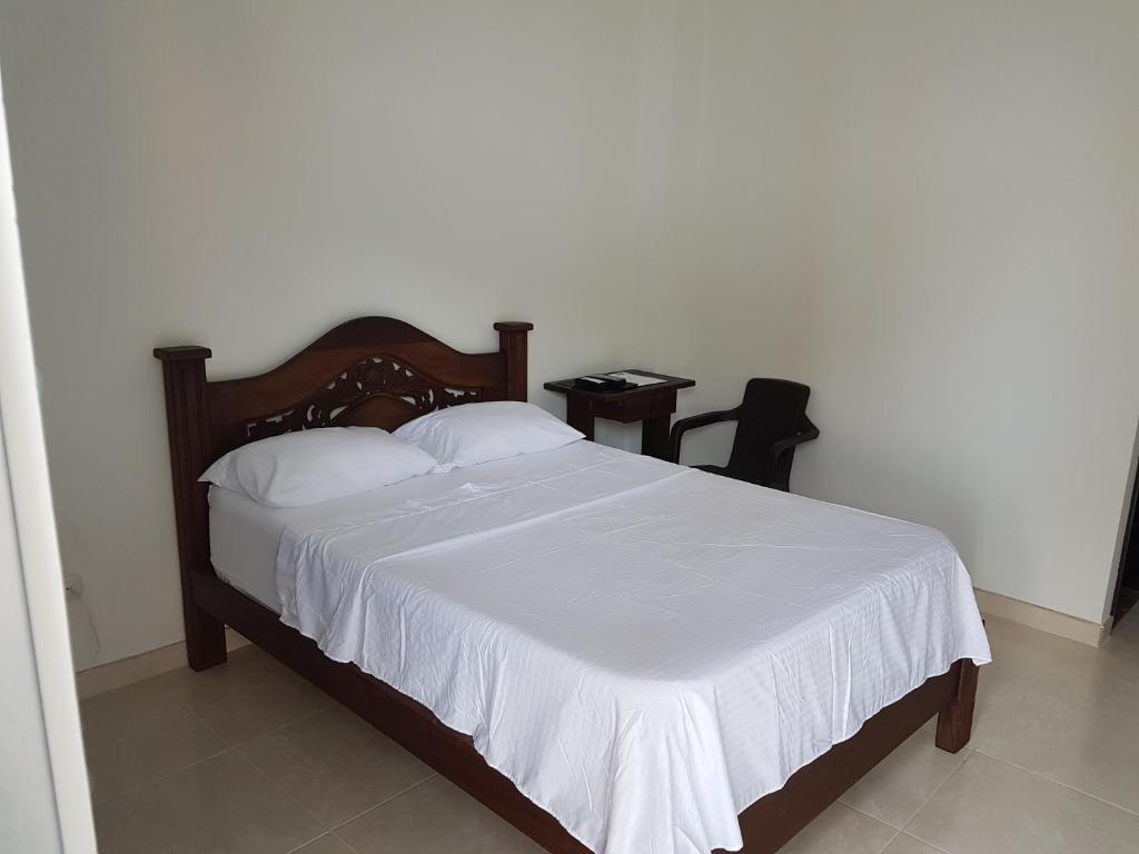 Postel nebo postele na pokoji v ubytování Hotel Palmari