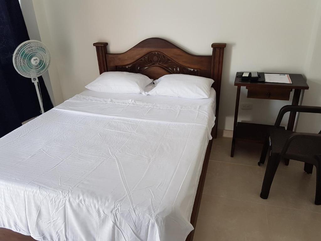 Postel nebo postele na pokoji v ubytování Hotel Palmari