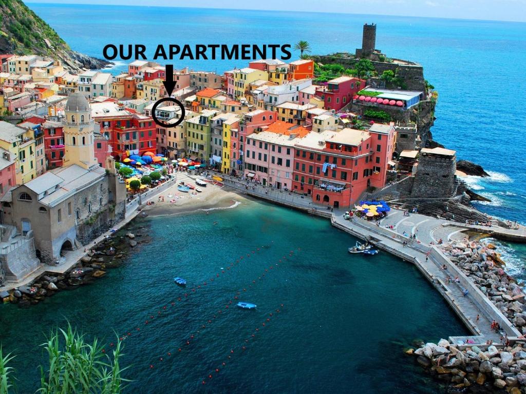 an aerial view of a city with a clock on top at MADA Charm Apartments Terrace&Carugio in Vernazza