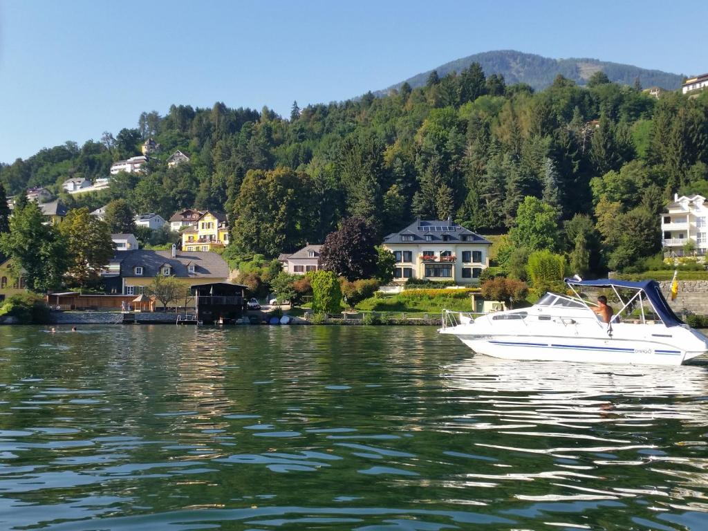 a white boat floating on a body of water at Villa Margarethe in Millstatt