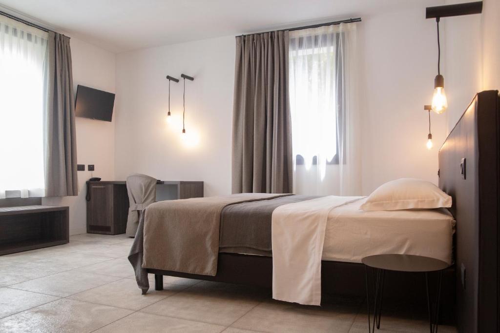 Posteľ alebo postele v izbe v ubytovaní taverna napoleone