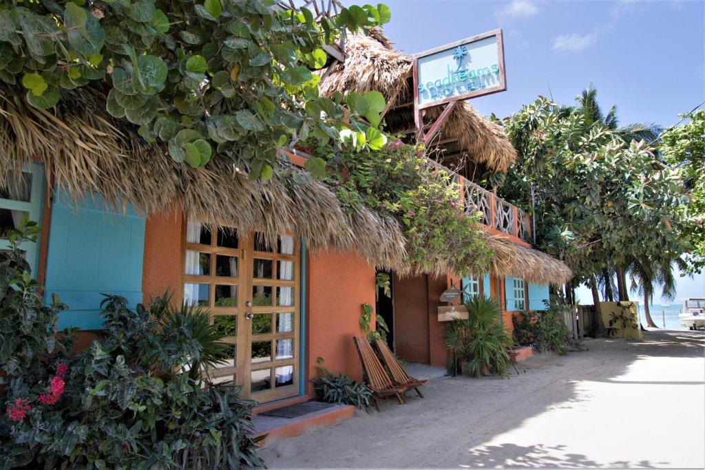 a building with a sign on the side of it at Sea Dreams Hotel in Caye Caulker