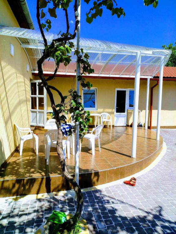 a house with a porch with a table and chairs at Private House in Berehove