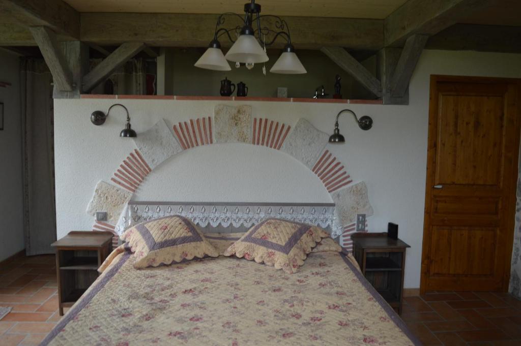 a bedroom with a large bed with two pillows on it at Ellesmere in Bazens