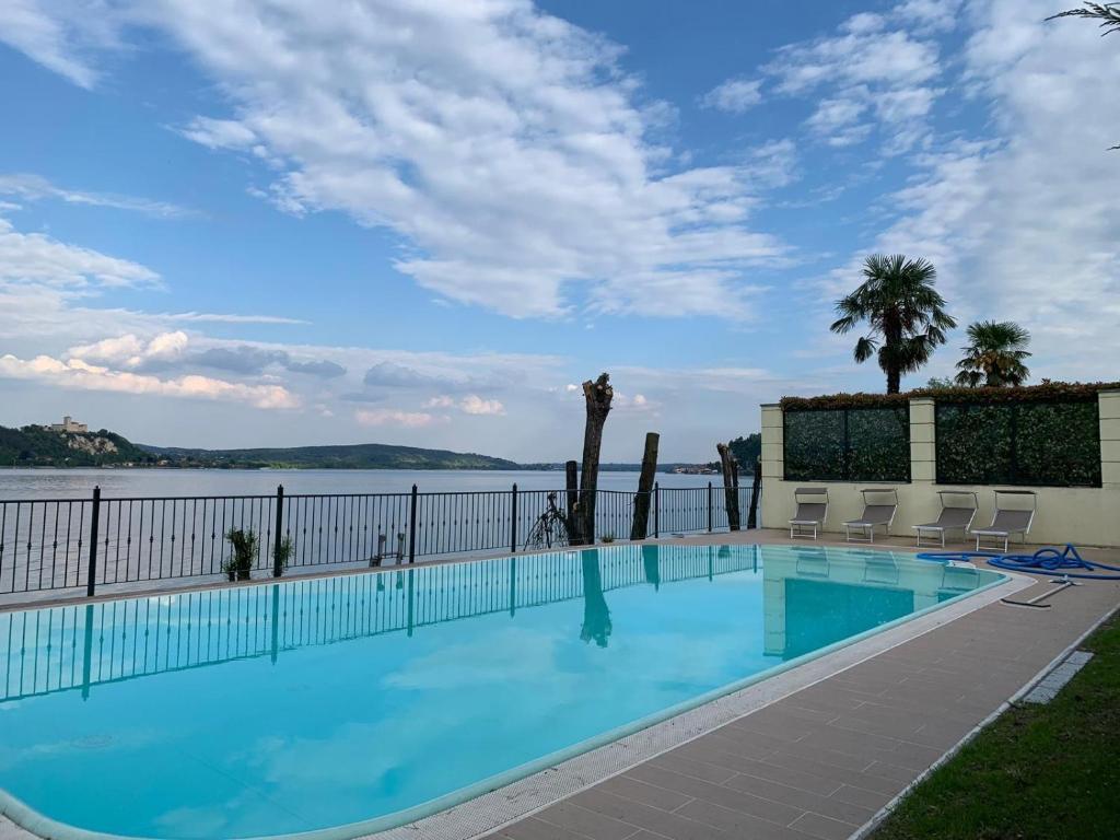 a swimming pool with a view of the water at Residence Villa Greta in Meina