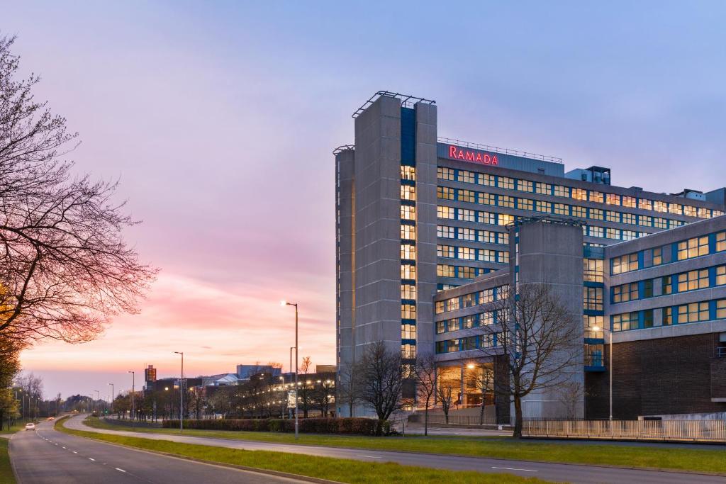 a building with a sign on the side of it at Ramada East Kilbride in East Kilbride