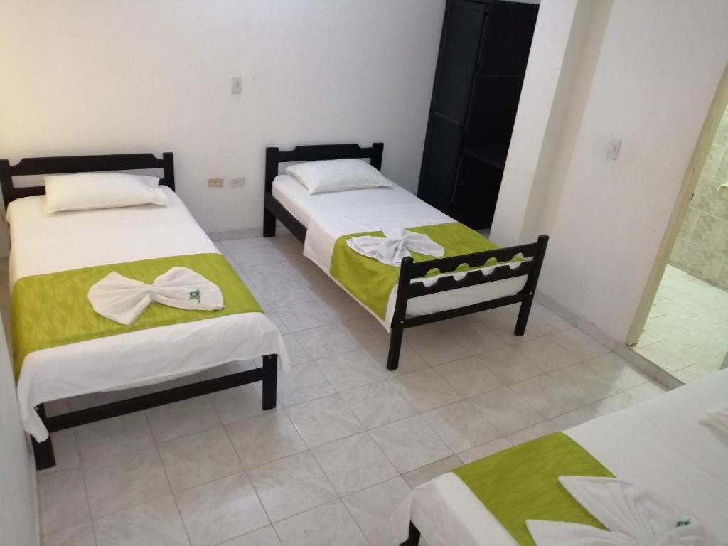 Postel nebo postele na pokoji v ubytování Hotel Tame Real