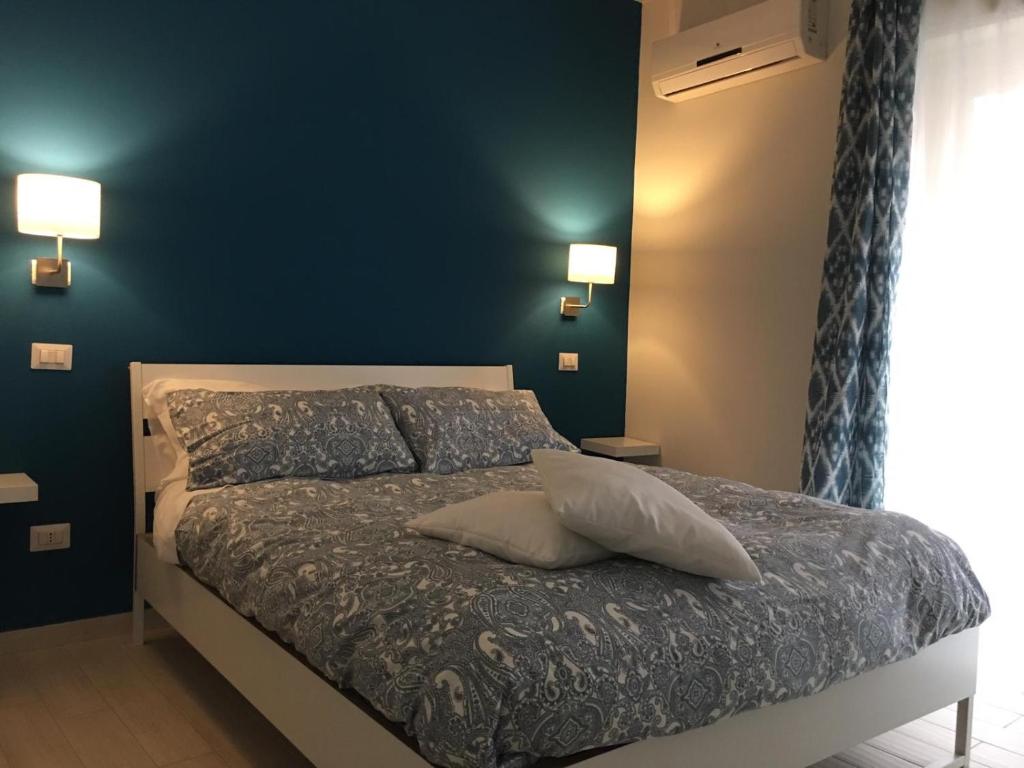 a bed with a white bedspread and pillows at Borgo 22 in Catania